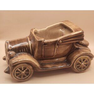 McCoy pottery planter  an antique convertible car produced in the USA.
